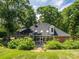 Beautiful brick home featuring a lush green lawn and abundant shrubbery at 3964 Deer Run Ne Dr, Conover, NC 28613