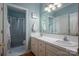 Bathroom with double sinks, tile countertop, and a shower/tub with tile surround at 3964 Deer Run Ne Dr, Conover, NC 28613