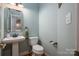 Half bathroom with pedestal sink and toilet at 3964 Deer Run Ne Dr, Conover, NC 28613