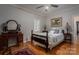 Charming bedroom features a queen-size bed, hardwood floors, and a vintage vanity table at 3964 Deer Run Ne Dr, Conover, NC 28613
