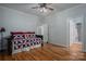 Spacious bedroom features hardwood floors, ceiling fan, and a daybed with colorful pillows at 3964 Deer Run Ne Dr, Conover, NC 28613