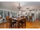 Spacious dining room leading to a kitchen featuring white cabinets and stainless steel appliances at 3964 Deer Run Ne Dr, Conover, NC 28613