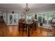 Bright dining room with wood floors, a chandelier, and large windows offering plenty of natural light at 3964 Deer Run Ne Dr, Conover, NC 28613