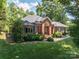 Brick home featuring an attached garage and a well-maintained lawn at 3964 Deer Run Ne Dr, Conover, NC 28613