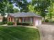 Brick home featuring an attached garage and a well-maintained lawn at 3964 Deer Run Ne Dr, Conover, NC 28613