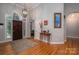 Grand foyer featuring hardwood floors, an elegant light fixture, and a striking front door at 3964 Deer Run Ne Dr, Conover, NC 28613