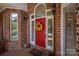Inviting front door with a decorative wreath and sidelight windows at 3964 Deer Run Ne Dr, Conover, NC 28613