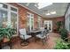 Sunroom featuring brick flooring and walls, windows, ceiling fans, and patio furniture at 3964 Deer Run Ne Dr, Conover, NC 28613
