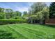 Beautifully landscaped backyard with a well-manicured lawn and charming pergola at 418 3Rd Ne St, Hickory, NC 28601
