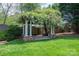 Idyllic backyard featuring a pergola with climbing vines, providing a serene outdoor space at 418 3Rd Ne St, Hickory, NC 28601