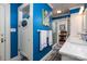 Vibrant bathroom with blue walls, glass shower, and unique design elements, offering a refreshing space at 418 3Rd Ne St, Hickory, NC 28601