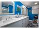 Bright bathroom with blue walls, double sinks, and marble countertops, showcasing a fresh design at 418 3Rd Ne St, Hickory, NC 28601