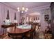 Charming dining room features a swan centerpiece, draped pink curtains, and a view into the next living area at 418 3Rd Ne St, Hickory, NC 28601