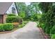 Long, winding driveway leading to the home, surrounded by lush greenery and mature trees at 418 3Rd Ne St, Hickory, NC 28601