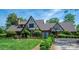 Charming Tudor-style home with lush landscaping and well-manicured lawn at 418 3Rd Ne St, Hickory, NC 28601
