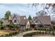 Stately Tudor-style home with well-manicured landscaping and a brick pathway to the entrance at 418 3Rd Ne St, Hickory, NC 28601
