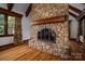Close-up of the impressive stone fireplace with a wood mantel and hearth at 418 3Rd Ne St, Hickory, NC 28601