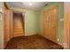 Charming foyer featuring brick flooring, a wooden front door, and staircase leading to the upper level at 418 3Rd Ne St, Hickory, NC 28601