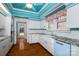 Retro kitchen with white cabinets, marble countertops, and a farmhouse sink and blue appliances at 418 3Rd Ne St, Hickory, NC 28601