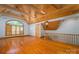 Bright living room with high ceilings, wooden beams, hardwood flooring, and a large window with shutters at 418 3Rd Ne St, Hickory, NC 28601