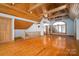 Inviting living room with wood floors, exposed beams, a pendant light, and multiple windows for natural light at 418 3Rd Ne St, Hickory, NC 28601
