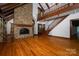 Spacious living room with stone fireplace, hardwood floors, and elegant staircase at 418 3Rd Ne St, Hickory, NC 28601