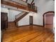 Open-concept living room with hardwood floors and a staircase leading to a second-story landing at 418 3Rd Ne St, Hickory, NC 28601