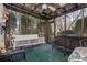 Relaxing screened porch with wicker furniture, a ceiling fan, and views of the surrounding greenery at 418 3Rd Ne St, Hickory, NC 28601