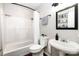 Bathroom featuring a white shower/tub, a dark framed mirror, and a pedestal sink at 4603 Oakwood Cir, Gastonia, NC 28056