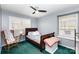 Bedroom featuring a rocking chair, ceiling fan, and two windows at 4603 Oakwood Cir, Gastonia, NC 28056