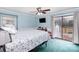 Bright bedroom featuring a ceiling fan, sliding glass door access to the outside, and a wall-mounted television at 4603 Oakwood Cir, Gastonia, NC 28056