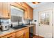 The kitchen features wood cabinets, dark countertops and sink, and a window at 4603 Oakwood Cir, Gastonia, NC 28056
