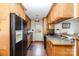 The kitchen features wood cabinets, black appliances, and dark countertops at 4603 Oakwood Cir, Gastonia, NC 28056