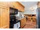 View of the kitchen featuring wooden cabinets and black appliances at 4603 Oakwood Cir, Gastonia, NC 28056