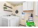 Bright laundry room with modern washer and dryer, complemented by decorative shelves at 4603 Oakwood Cir, Gastonia, NC 28056