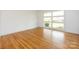Bright bedroom with hardwood floors and a large window offering natural light and neighborhood views at 4625 Woodlark Ln, Charlotte, NC 28211