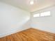 Bedroom features hardwood floors, white walls, and natural lighting at 4625 Woodlark Ln, Charlotte, NC 28211