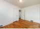 Bedroom featuring wood floors, white walls, and a closet at 4625 Woodlark Ln, Charlotte, NC 28211