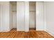 A view inside the bedroom closet with white sliding doors and wooden floors at 4625 Woodlark Ln, Charlotte, NC 28211