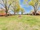 Lush green community lawn with mature trees and charming brick residential buildings in a serene neighborhood setting at 4625 Woodlark Ln, Charlotte, NC 28211