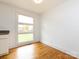 Bright dining area with hardwood floors and large windows offering abundant natural light and a pleasant view at 4625 Woodlark Ln, Charlotte, NC 28211