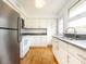 Well-lit kitchen with stainless steel appliances, white cabinets, and a sink, ready for culinary adventures at 4625 Woodlark Ln, Charlotte, NC 28211