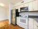 Modern kitchen with stainless steel appliances, white cabinetry, offering ample space for cooking at 4625 Woodlark Ln, Charlotte, NC 28211