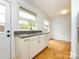 Clean kitchenette area featuring a sink, white cabinets, and an adjacent dining space at 4625 Woodlark Ln, Charlotte, NC 28211