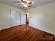 Bedroom with hardwood floors, fan, and large closet for storage at 511 W Main St, Cleveland, NC 27013