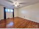 Large bedroom with ceiling fan and hardwood floors is bright and inviting at 511 W Main St, Cleveland, NC 27013