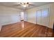 Bedroom features hardwood floors, fan, and closet with sliding doors at 511 W Main St, Cleveland, NC 27013