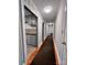 Hallway with fresh paint and carpet leads to the kitchen and other bedrooms at 511 W Main St, Cleveland, NC 27013