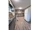 Open kitchen boasts gray cabinetry, updated appliances, and vinyl flooring at 511 W Main St, Cleveland, NC 27013