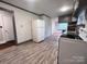 Functional kitchen with white appliances, gray cabinets, and plank flooring, creating a clean and modern look at 511 W Main St, Cleveland, NC 27013